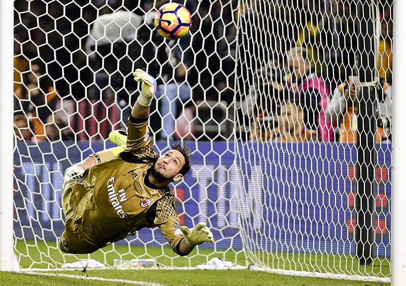 FILE - AC Milan goalkeeper Gianluigi Donnarumma saves a penalty during the Italian Super Cup soccer match between Juventus and AC Milan, at the Al Sadd Sports Club in Doha, Qatar, on Friday, December 23, 2016. Photo: AP