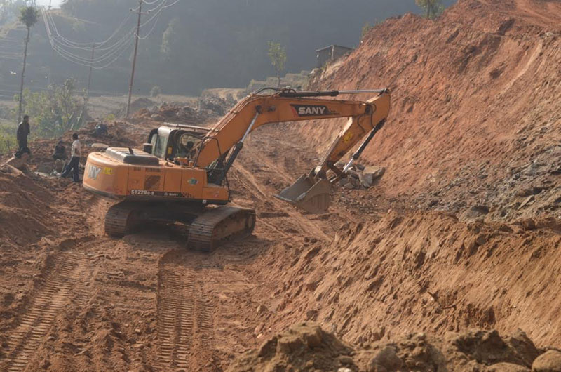 An excavator being used to expand the road along the Adamghat-Chautara road section at Kiranchowk VDC, in Dhading, on Monday, February 20, 2017. Photo: THT