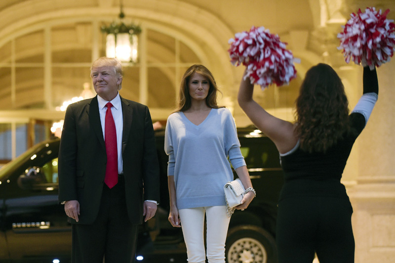 President Donald Trump and first lady Melania Trump watch the Palm Beach Central High School Band as they play for their arrival at Trump International Golf Club in West Palm Beach, Fla., Sunday, Feb. 5, 2017. Photo: AP