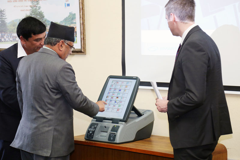 Prime Minister Pushpa Kamal Dahal inspects an electronic voting machine at the Election Commission in Kathmandu on Tuesday, February 7, 2017. Photo Courtesy: PM's Secretariat