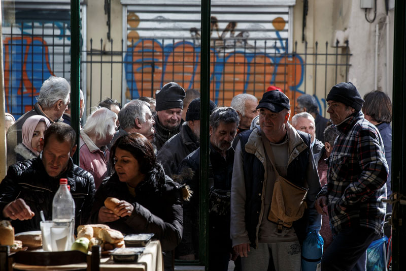 People line up as they wait to enter a soup kitchen run by the Orthodox church in Athens, Greece,  on February 15, 2017. Photo: Reuters