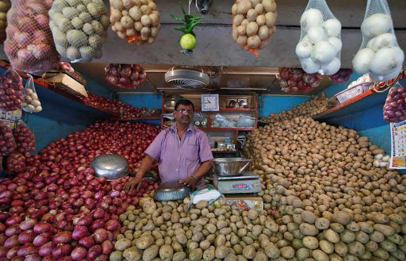 A vendor waits for customers at his vegetable stall at a wholesale fruit and vegetable market in Mumbai, India, on February 13, 2017. Photo: Reuters