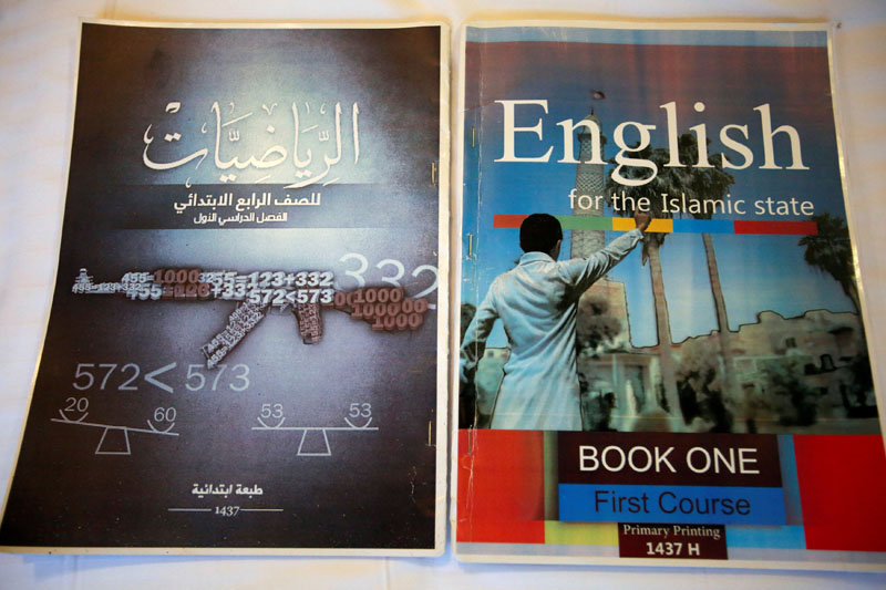 Math and English textbooks found in an Islamic State facility for child fighters, which include military imagery, are pictured in Mosul, Iraq, on February 16, 2017. Photo: Reuters