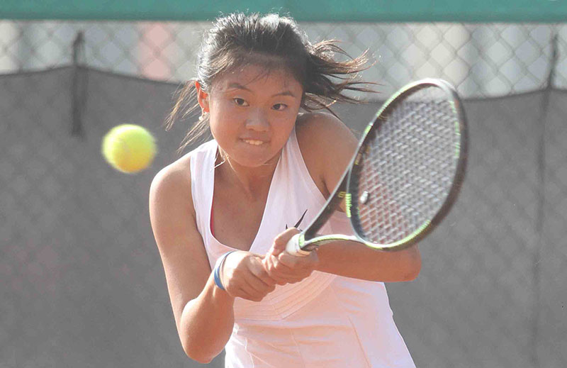 Yujiao Che of China returns to Punnin Kovapitukted of Thailand during their Nepal ITF Junior U-18 Circuit-I Tennis Championship match in Lalitpur on Thursday, February 9, 2017. Che won the match 3-6, 6-2, 7-6. Photo: Udipt Singh Chhetry/THT