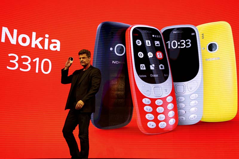 Arto Nummela, CEO of Nokia-HMD, holds up Nokia 3310 device during presentation ceremony at Mobile World Congress in Barcelona, Spain, on Sunday, February 26, 2017. Photo: Reuters