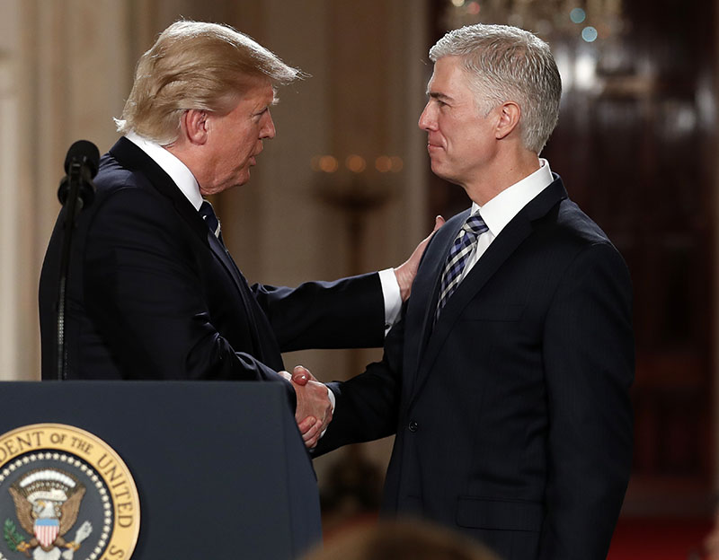 President Donald Trump shakes hands with 10th US Circuit Court of Appeals Judge Neil Gorsuch, his choice for Supreme Court associate justice in the East Room of the White House in Washington. Gorsuch recalls being blinded by tears in the middle of a ski run after someone rang his cellphone with news of the unexpected death of Supreme Court Justice Antonin Scalia, on  January 31, 2017. Photo: AP