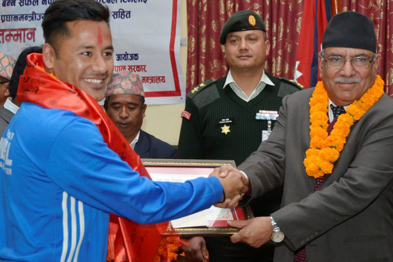 Nepal's national football team captain Anil Gurung shakes hands with PM Pushpa Kamal Dahal after being honoured for winning the AFC Solidarity Cup, at the latter's residence in Baluwatar, Kathmandu, on Monday, February 13, 2017. Photo Courtesy: PM's Secretariat