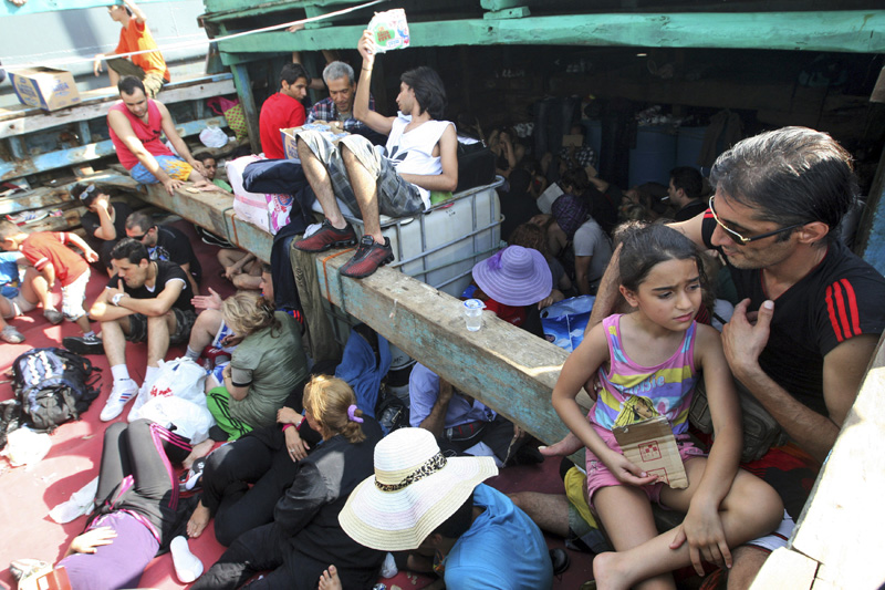 FILE - In this May 12, 2013, file photo, Iranian refugees who were caught in Indonesian waters while sailing to Australia sit on a boat at Benoa port in Bali, Indonesia. Photo: AP