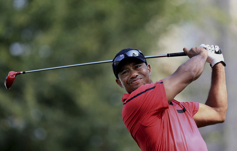 FILE - In this Feb. 2, 2014 file photo, Tiger Woods  tees off at the 14th hole during the final round of the Dubai Desert Classic golf tournament in Dubai, United Arab Emirates. Photo: AP