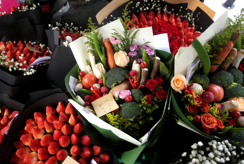 Bouquets made of vegetables, strawberries and flowers are seen in a vehicle as a delivery staff of a florist prepares to deliver them for clients on Valentine's Day in Beijing, China, on February 14, 2017. Photo: Reuters