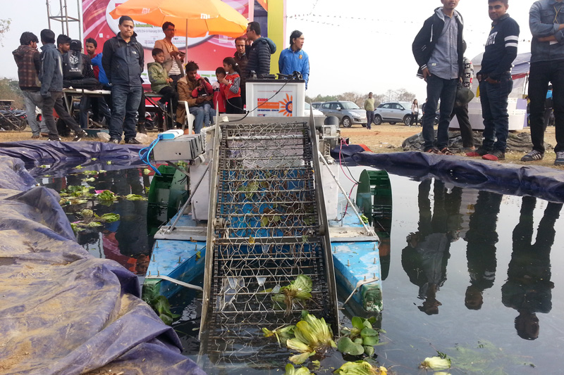 Visitors observe a technology to control hyacinth in ponds and lakes, exhibited at the CAN Info-Tech, in Pokhara of Kaski district, on Saturday, February 18, 2017. Photo: Rup Narayan Dhakal 