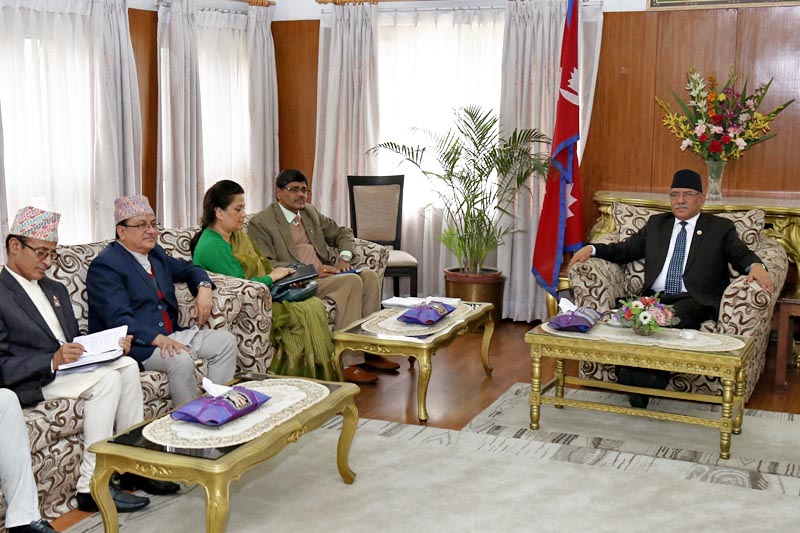 Chief Commissioner of Election Commission Dr. Ayodhi Prasad Yadav along with other commissioners briefs PM Pushpa Kamal Dahal about the upcoming local level elections at the PM's official residence in Baluwatar, Kathmandu, on Thursday, March 30, 2017. Photo: RSS
