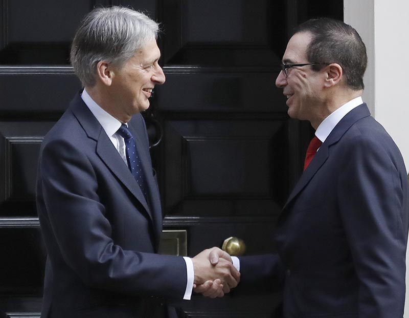 Britain's Chancellor Philip Hammond welcomes the US Secretary of the Treasury Steven Mnuchin (right) at 11 Downing Street in London, Thursday, March 16, 2017. Photo: AP