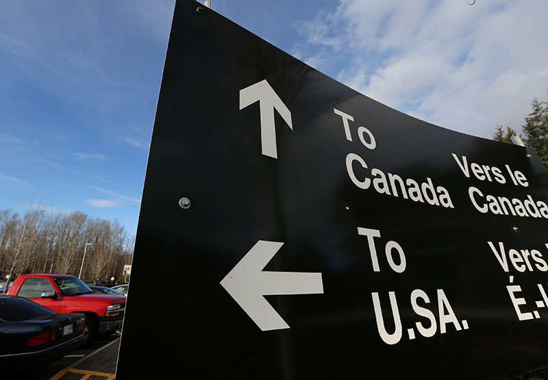 A sign giving directions is seen in the parking lot of the United States-Canada border in Surrey, British Columbia, Canada, on February 16, 2017. Photo: Reuters