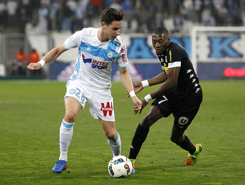 Marseille's Florian Thauvin (left) challenges for the ball with Angers' Karl Toko Ekambi, during the League One soccer match between Marseille and Angers, at the Velodrome Stadium, on Friday, March 10, 2017. Photo: AP