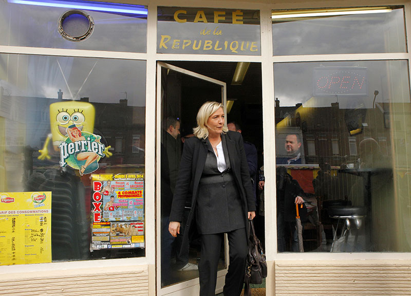 FILE - French far-right party leader Marine Le Pen exits a cafe in Henin-Beaumont, northern France, on March 21 , 2014. Photo: AP