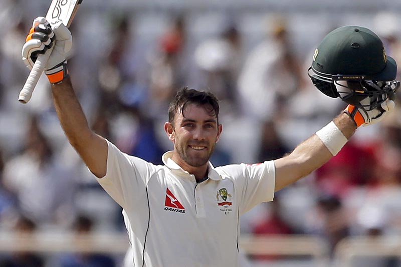 Australia's Glenn Maxwell raises his bat and helmet to celebrate scoring a century during the second day of the third test cricket match against India in Ranchi, India, Friday, March 17, 2017. Photo: AP