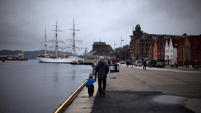 File - A man walks with a child near the marina in downtown Bergen, southwestern Norway, on March 20, 2012.  Photo: Reuters