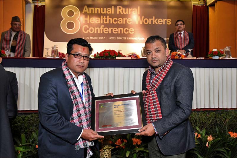 Minister for Health Gagan Kumar Thapa presents the Nick Simons Award 2016 to Public Health Inspector Bal Gopal Shrestha, stationed at a health post in Pyuthan district, amid the eighth Annual Rural Health Workers Conference organised in the Kathmandu, on Wednesday, March 22, 2017. Photo: RSS