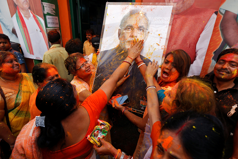 Supporters of the Bharatiya Janata Party (BJP) celebrate after learning of the initial poll results outside the party headquarters in Kolkata, India, on March 11, 2017. Photo: REUTERS