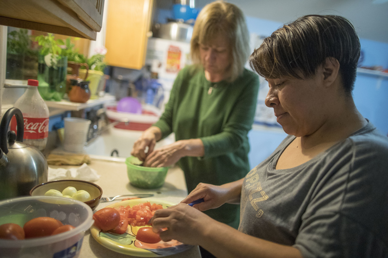 In this Tuesday, Feb. 28, 2017 photo, Ruth Silverberg, left, helps Maribel Torres prepare dinner at Maribel's home in the Staten Island borough of New York. Photo: AP