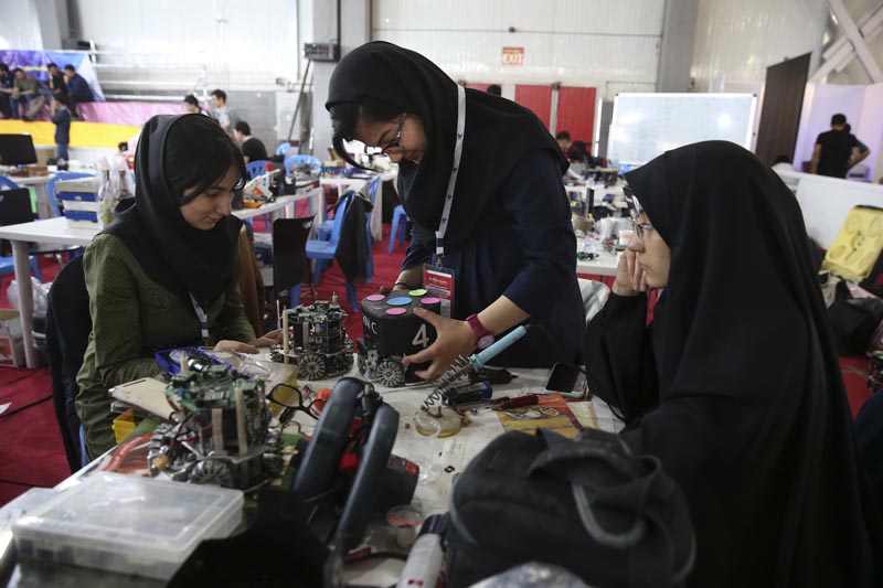 FILE - In this April 6, 2016, file photo, Iranian students prepare their robots during the international robotics competition, RoboCup Iran Open 2016, in Tehran, Iran. Universities in the US say President Donald Trump's revised travel ban would block hundreds of graduate students who play key roles in research. Twenty-five of America's largest universities told The Associated Press they've sent acceptance letters to more than 500 students from the six banned countries for next fall, mostly from Iran, who are known for their strength in engineering and sciences. Photo: AP