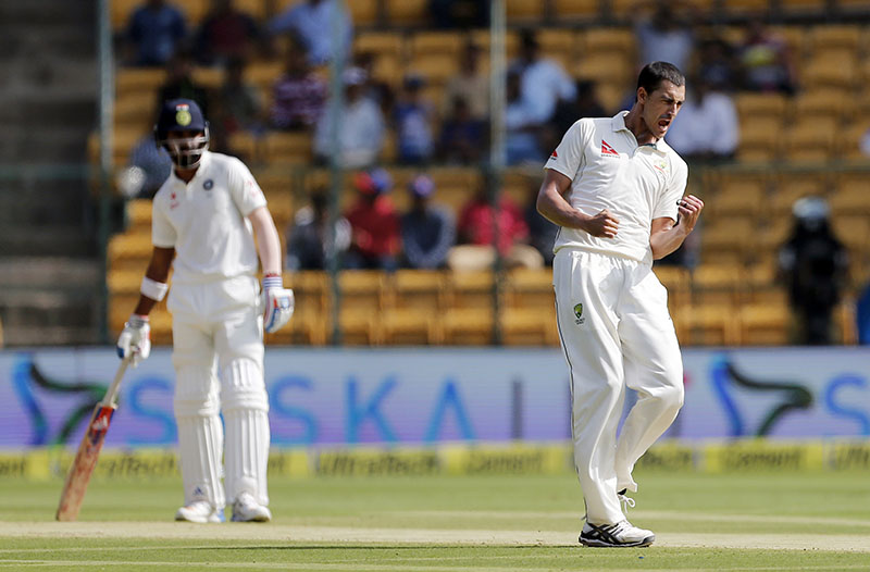 Australia's Mitchell Starc (right) celebrates the dismissal of India's Abhinav Mukund during the first day of the second test cricket match in Bangalore, India, on Saturday, March 4, 2017. On the left is India's Lokesh Rahul. Photo: AP