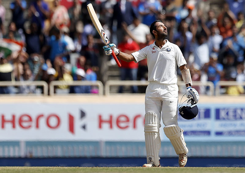 India's Cheteshwar Pujara looks skywards and raises his bat to celebrate scoring a century during the third day of the third test cricket match against Australia in Ranchi, India, on Saturday, March 18, 2017. Photo: AP
