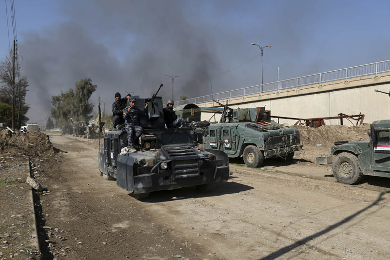 Iraqi security forces advance during fighting against Islamic State militants, in western Mosul, Iraq, Monday, March 6, 2017. Photo: AP