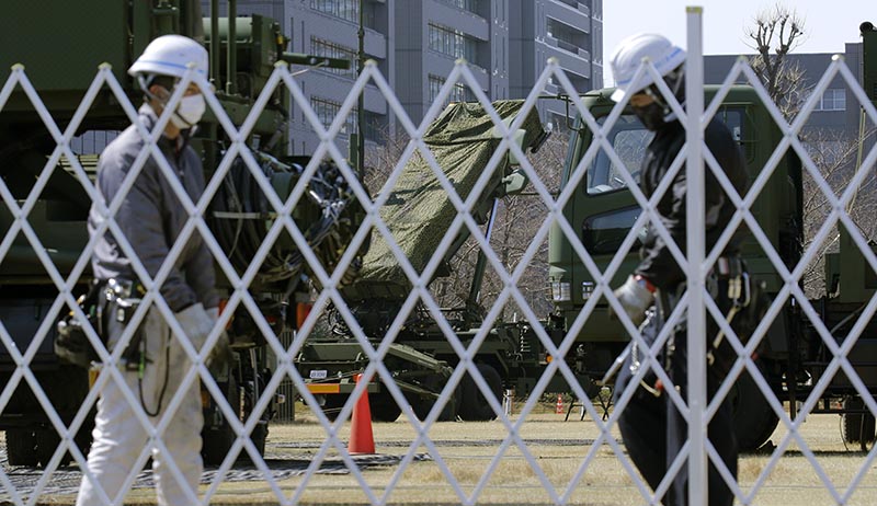 Workers set up a fence around the PAC-3 Patriot missile unit deployed against North Korea's missile firing at the Defense Ministry in Tokyo, on Wednesday, March 22, 2017. Photo: AP