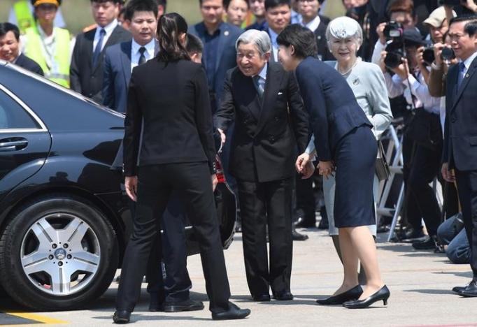 Japan's Emperor Akihito (C) and Empress Michiko (center R) arrive at Phu Bai airport in the central city of Hue as they prepare to departure for Thailand, March 5, 2017. REUTERS/Hoang Dinh Nam