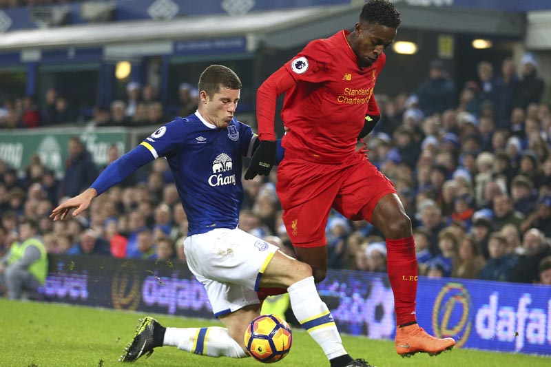 FILE - This is a Monday, Dec. 19, 2016  file photo of Liverpool's Divock Origi, right, competes for the ball with Everton's Ross Barkley during the English Premier League soccer match between Everton and Liverpool at Goodison Park stadium in Liverpool, England. Photo: AP
