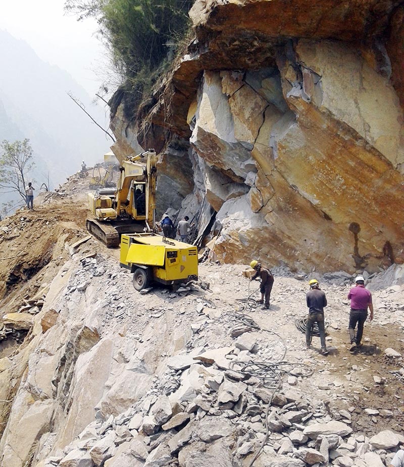 Construction workers carry on with their work on the road, in Baitadi district, on Thursday, March 16, 2017. The under-construction road links Dharchula of northern India with Mansarovar in Tibet. Photo: RSS