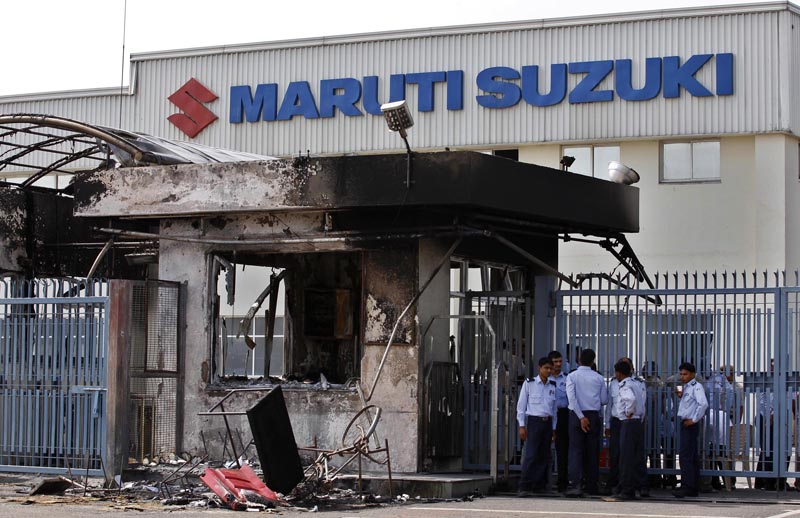 FILE - In this July 19, 2012, file photo, security guards stand near a burnt down reception block of Maruti Suzuki factory in Manesar, near New Delhi, India. Photo: AP