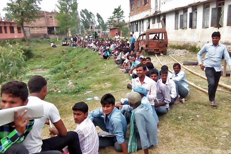 Locals sit in queue to submit their applications for the vacant positions of temporary police for the upcoming local level polls, in Gaur, of Rautahat district, on Wednesday, March 29, 2017. Photo: Prabhat Kumar Jhapa