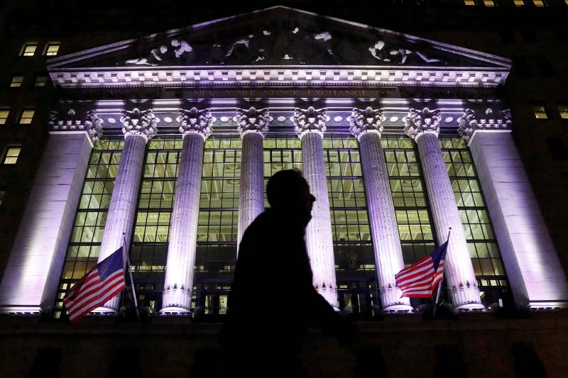 File-A commuter passes by the New York Stock Exchange (NYSE) in the financial district in New York City, US, on February 7, 2017. Photo: Reuters
