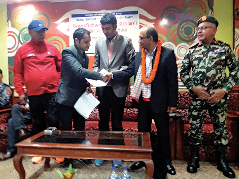 ND Engineering Consultancy Chairperson Niranjan Dumre (left) shakes hands with MoYS Secretary Mahesh Dahal as Western Regional Sports Development Committee Chairperson Khaga Raj Poudel (centre) and other officials look on during a signing ceremony in Pokhara on Thursday, March 9, 2017. Photo: THT