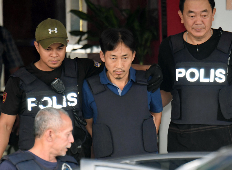 North Korean Ri Jong Chol, center, who was arrested in connection with the death of Kim Jong Un's half-brother, is transferred from Sepang district police station in Sepang, Malaysia Friday, March 3, 2017. Photo: AP