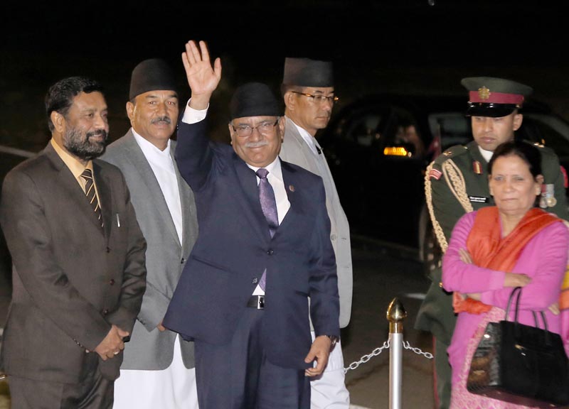 Prime Minister Pushpa Kamal Dahal waves his hand before flying to Boao, at the TIA in Kathmandu. Photo: RSS