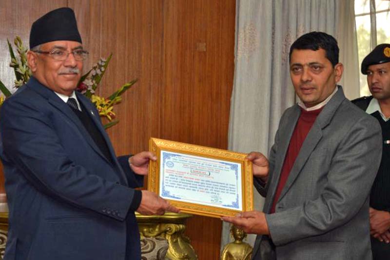 Prime Minister Pushpa Kamal Dahal accepts the certificate of appreciation from National Milk Producers' Society Chairman Ananda Prasad Neure at the PM's residence in Baluwatar, on Monday, March 6, 2017. Photo Courtesy: PM's Secretariat