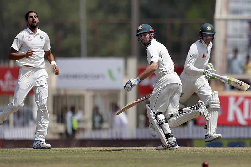 India's Ishant Sharma, left, watches as Australia's Peter Handscomb, right, and Shaun Marsh run between the wickets to score runs during the fifth day of their third test cricket match against India in Ranchi, India, Monday, March 20, 2017. Photo: AP
