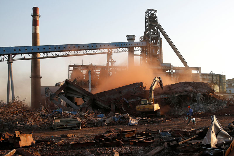 A worker walks at a demolished quarter at a steel plant of Hangzhou Iron&amp;Steel Group company, which was shut down as part of the city's scheme to improve air quality, in Hangzhou, Zhejiang province, China, on March 2, 2017. Photo: Reuters