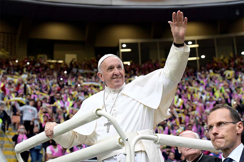 Pope Francis waves to confirmation candidates at San Siro Stadium in Milan, Italy, on March 25, 2017. Photo: Osservatore Romano via Reuters