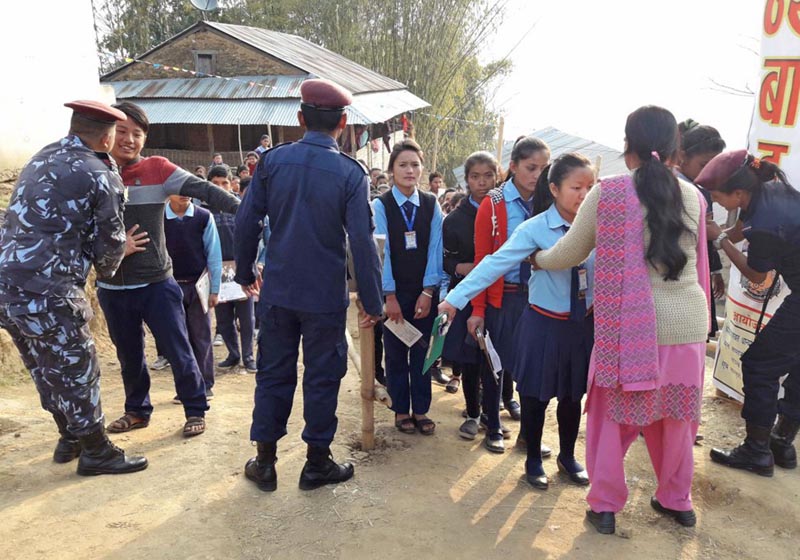 Security personnel checking students before they entered the SEE examination centre at Pancha Secondary School at Diktel, Khotang on Thursday, Marcha 16, 2017. Photo: RSS