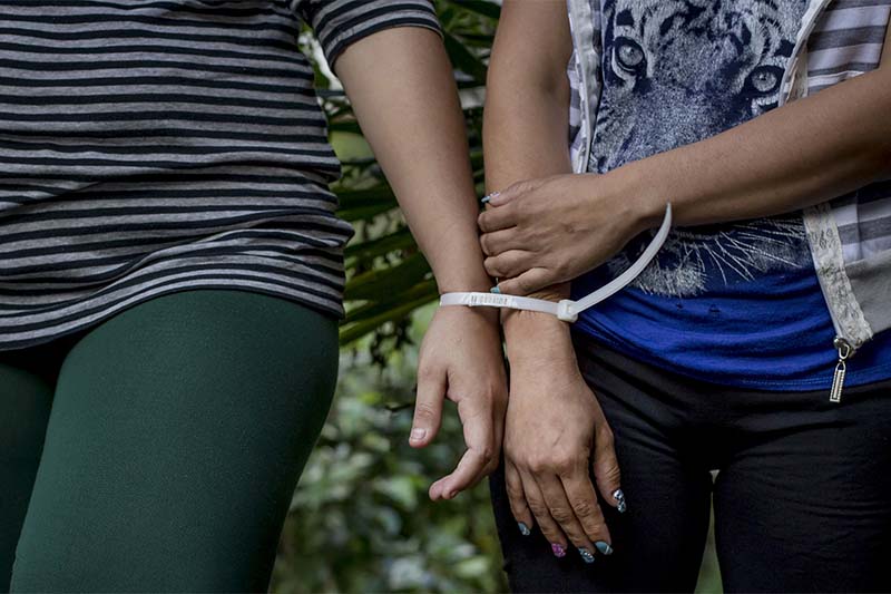 FILE- Two women who are accused by police of being part of the Mara Salvatrucha Gang are presented to the media at police headquarters in San Salvador, El Salvador, on December 8, 2016. Photo: AP