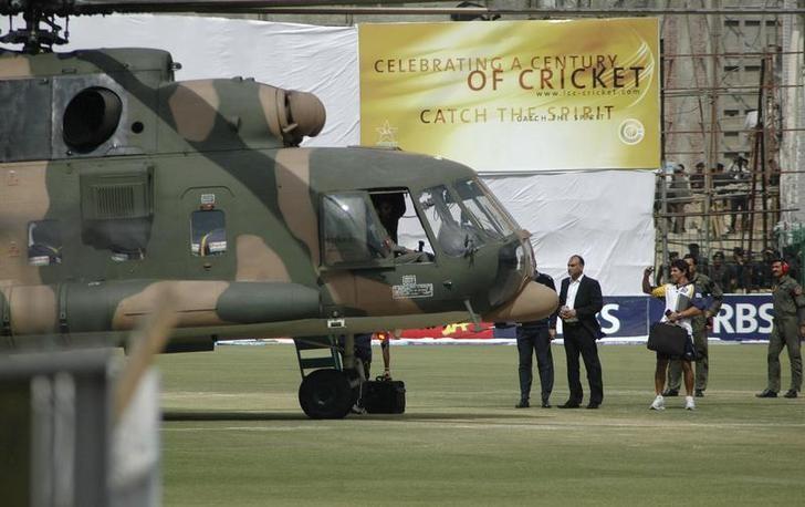Sri Lanka's cricket team members prepare to board a Pakistani military helicopter at the Gaddafi stadium after their team bus was attacked by gunmen while on the way to the stadium in Lahore March 3, 2009. REUTERS/Syed Mujtaba/Files