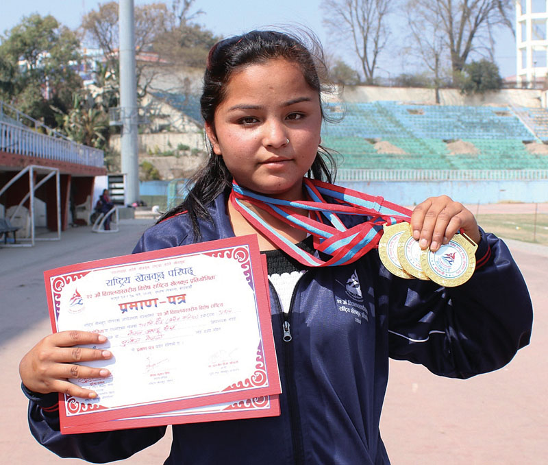 Sunita Nepali of Ganga HS School poses for a photo after winning three gold medals in the 22nd Inter-school Special Sports Meet at the Dasharath Stadium in Kathmandu on Wednesday, March 1, 2017. Photo: THT