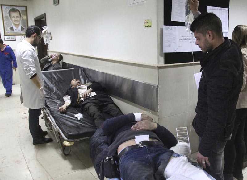 In this photo released by the Syrian official news agency SANA, Syrian injured men wait to receive medical treatments after they wounded in the main judicial building which attacked by a suicide bomber, in Damascus, Syria, Wednesday, March 15, 2017. Photo: AP