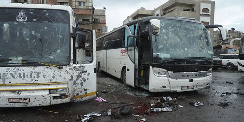 Blood soaked streets and several damaged buses in a parking lot at the site of an attack by twin explosions in Damascus, Syria, on Saturday, March 11, 2017. Twin explosions Saturday near religious shrines frequented by Shiite pilgrims in the Syrian capital Damascus killed dozens of people, Arab media and activists report. Photo: SANA via AP