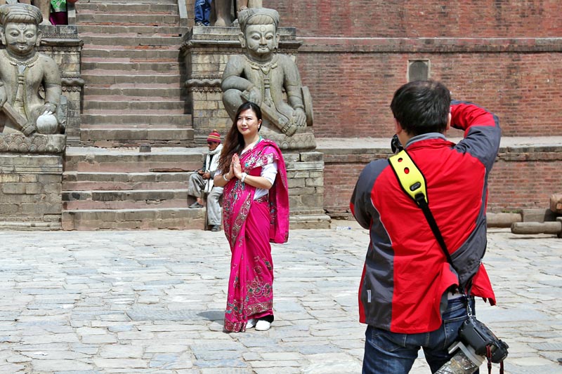 A tourist poses as her friend takes her snap at the Bhaktapur Durbar Square in Bhaktapur on Sunday, March 19, 2017. Photo: RSS